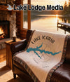Woven blanket with Lake Icaria map design and "Lake Lodge Media" text.