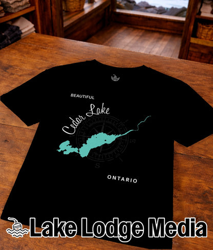 Black t-shirt with "Beautiful Cedar Lake Ontario" map graphic and "Lake Lodge Media" logo.