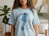 Light blue t-shirt with Barlow Lake, Michigan design and compass graphic.
