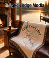 Fringe blanket with "East Lynn Lake West Virginia" and compass rose design on sofa.