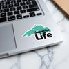 Turquoise map sticker with text "Superior Life" on a laptop.