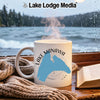 White mug with blue Lake Manawa map on it sits on a windowsill.