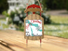 Christmas ornament shaped like a red and wood sled with "Merry Christmas from Lake Charlevoix" text.