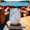 A white insulated wine tumbler with a Lake LBJ compass graphic sits on a boat table.