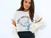 White t-shirt with "Lake Hartwell Georgia" text and compass design featuring a blue lake outline.