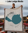 Woven blanket with Glen Lake and Michigan map design, held by a man.