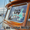 "Lure Life" sticker on a boat window with "Lake Lodge Media" text below.
