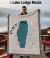 Man holding a blanket with a teal map of Black Lake, Idaho.