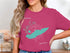 Teal Lake Erie map graphic with compass rose and text on a pink t-shirt.