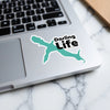 Teal shark sticker with "Darling Life" text on a laptop keyboard.