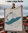 Man holding blanket with Lake Erie map and compass design.