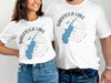 White t-shirts with Saratoga Lake, New York map and compass graphic.