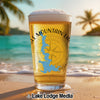 Glass of beer with a compass and map of Texas on a beach with palm trees.