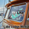 Turquoise ReelFoot Life sticker on a boat window with Lake Lodge Media branding.