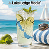 Glass with Chautauqua Lake design, ice, lime, mint, on beach with sailboat.