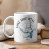 White mug with Lake Hartwell map and compass design, steaming with a drink.