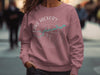 Pink sweatshirt with Lake Hickory North Carolina compass graphic and teal map detail.