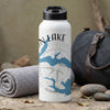 White water bottle with blue map and compass design on a textured surface.