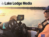Man in boat with fishing sonar at sunset over the water, "Lake Lodge Media" text.