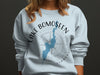 Light blue sweatshirt with Lake Bomoseen, Vermont map and compass graphic.