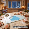 Glass cutting board featuring an Emerald Lake Canada map design, surrounded by holiday baking supplies on a kitchen counter.