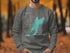 Gray sweatshirt with turquoise Snow Lake map and compass graphic.