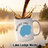 White mug with Buffalo Lake Minnesota design, coffee splashing into mug.