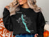 Black sweatshirt with "Long Lake Maine" and compass rose graphic.