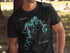 Black t-shirt with a teal compass graphic and "Pomme de Terre Lake Missouri" text.