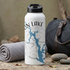 White water bottle with blue lake map and compass, next to a rolled towel and duffel.