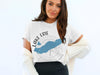 White t-shirt with blue Lake Erie graphic and compass design and "LAKE ERIE ONTARIO" text.