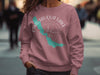 Pink sweatshirt with "Chautauqua Lake New York" text and compass.