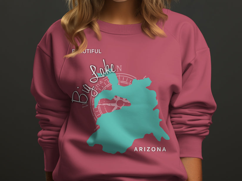 Teal Big Lake map graphic with compass on pink sweatshirt.