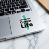 Sticker on laptop reads "Mosquito Creek Life" with a teal shape.