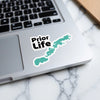 "Prior Life" text sticker with teal lake shape on a laptop.