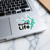 Bnotin Life sticker with teal lake outline on a laptop.