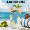 Glass with Lake Huron map and mint, on a beach with a sailboat.