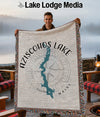 Man holds Aziscohos Lake Maine map blanket with compass design.