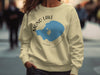 Yellow crewneck sweatshirt with Mono Lake, California graphic and compass.