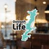 Oologah Life sticker on glass with a teal lake outline and copyright.