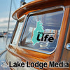 Derwentwater Life sticker on wooden boat window with Lake Lodge Media logo.
