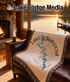 Woven blanket with Lake Tuscaloosa, Alabama map design on brown leather couch.