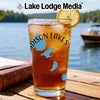 Glass with iced tea, lemon slice, and "Madison Lakes" design on a lake background.