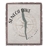 Woven blanket with "Seneca Lake" text, compass rose, and New York location.