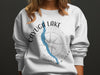 Crew neck sweatshirt with Cayuga Lake map graphic and compass rose logo.