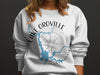 White sweatshirt with a "Lake Oroville California" graphic featuring a map and compass.