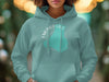 Teal hooded sweatshirt with "Emerald Lake Canada" map design and compass details.