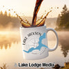 White mug with Lake Jackson Georgia graphic and compass, coffee pouring in.
