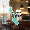 Keechelus Life sticker with a teal outline of a lake, visible on a window.