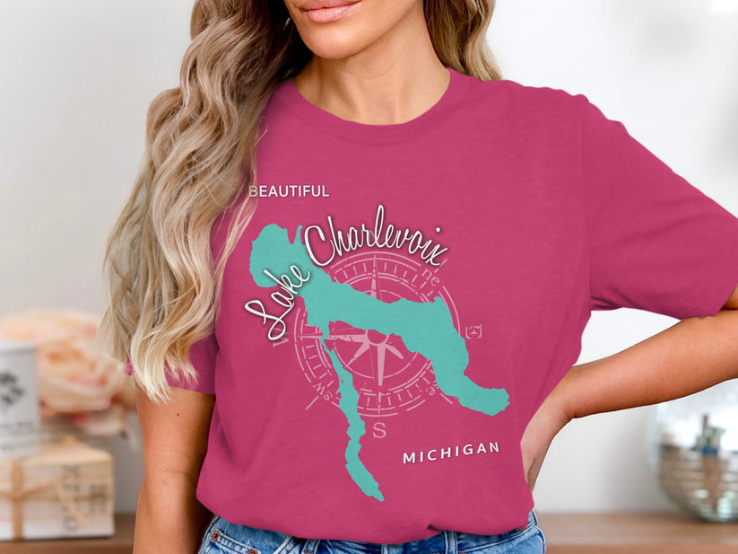 Pink t-shirt featuring a teal outline map of Lake Charlevoix and compass rose.